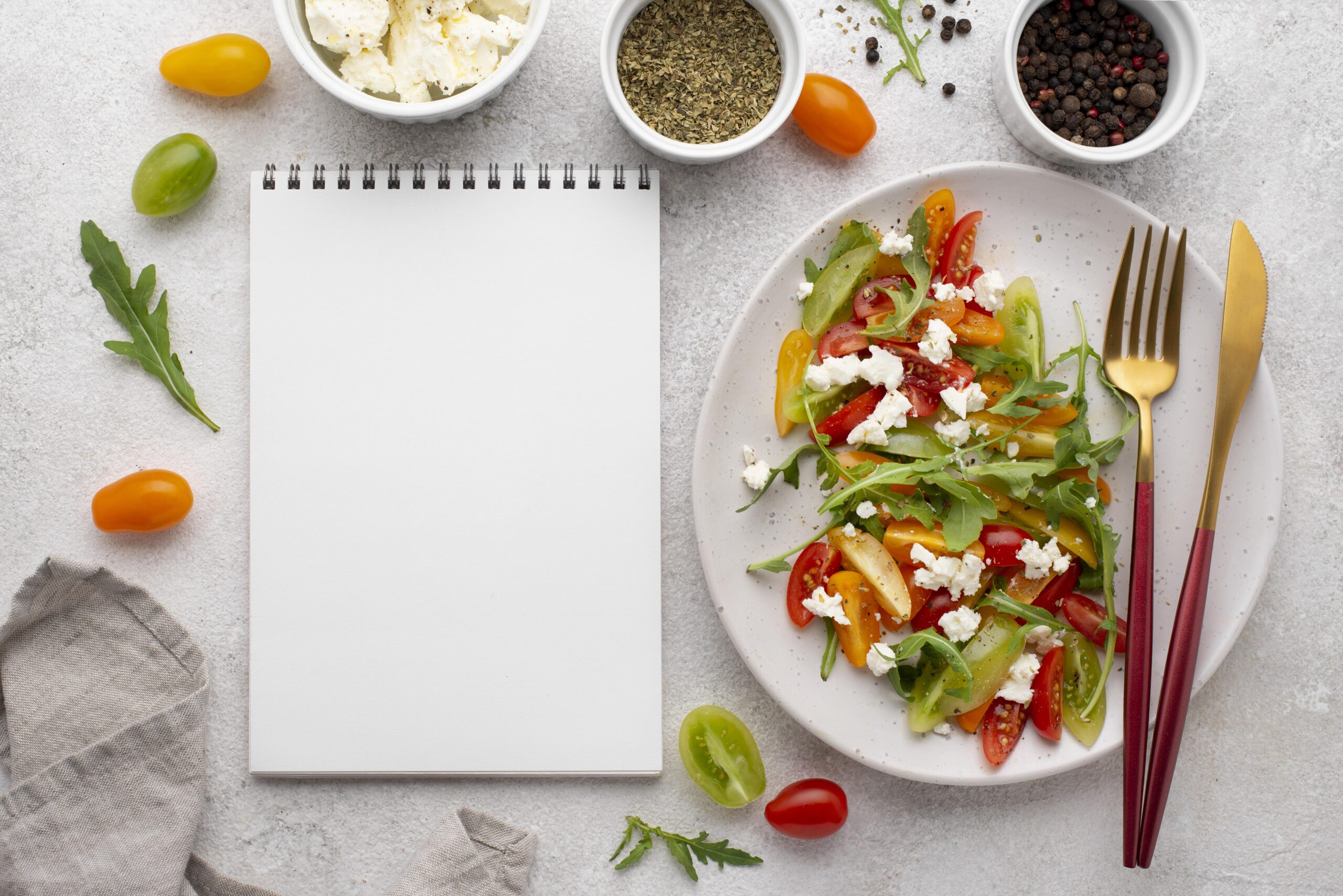 top-view-tomato-mix-salad-with-feta-cheese-rucola-blank-notebook.jpg